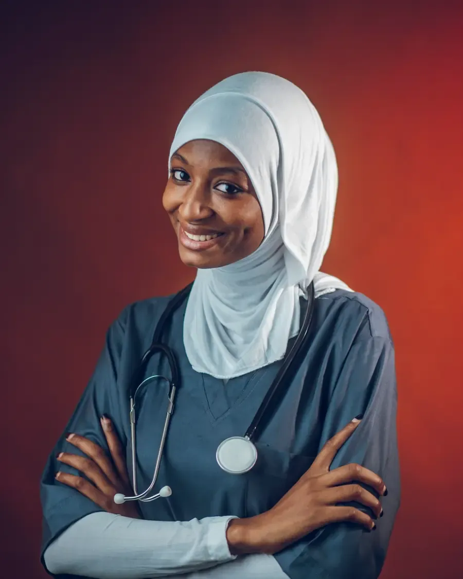 Smiling female doctor in a hijab and scrubs with a stethoscope
